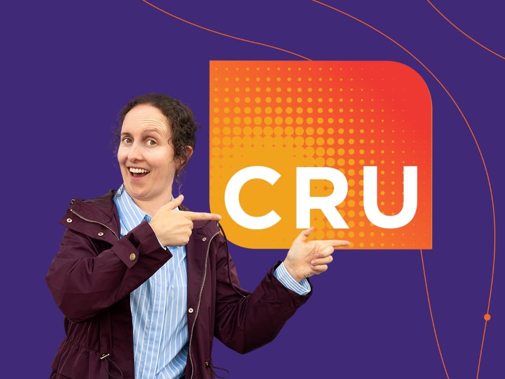 woman pointing to CRU logo